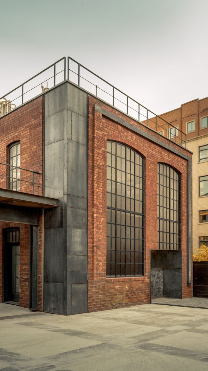 Raw urban grit meets refined industrial chic. This architectural masterpiece, clad in exposed brick and punctuated by stark metal accents, commands attention. Its minimalist design and factory-inspired aesthetic are a bold statement in the heart of the city. The interplay of raw materials and clean lines creates a space both powerful and serene.